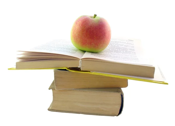 Stos z otwartą książkę i jabłko — Zdjęcie stockowe