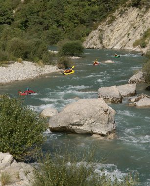 Kayaking on a wild river clipart