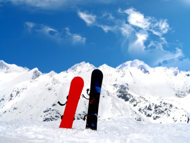 Mountain landscape with two snowboards clipart
