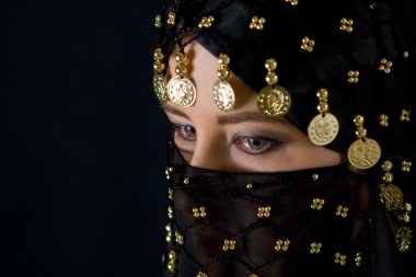 Mysterious eastern woman in black veil clipart