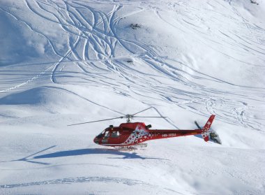 Rescue helicopter on duty in Swiss alps clipart