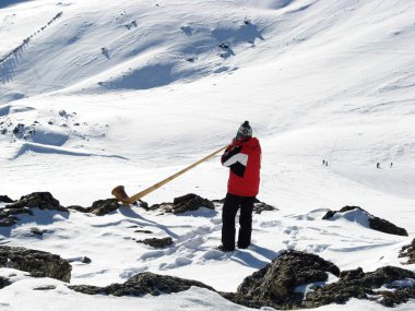 Man playing alp horn clipart