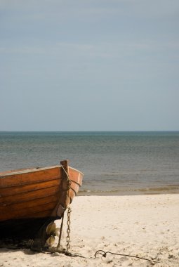 Wooden boat on the beach clipart