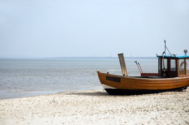 Wooden boat on the beach clipart