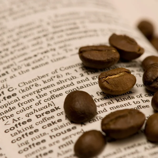 Coffee beans on book — Stock Photo, Image