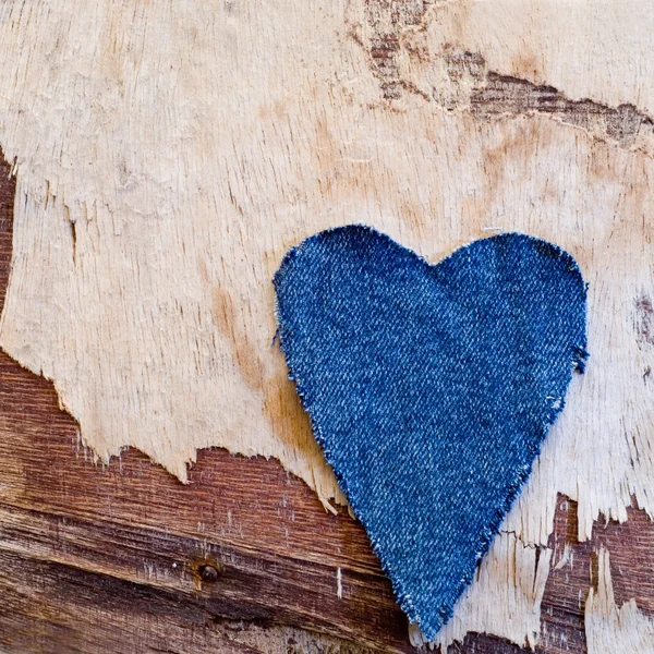 Jeans heart on driftwood plank — Stock Photo, Image