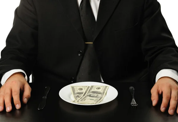 Бизнесмен, обедающий с долларами — стоковое фото