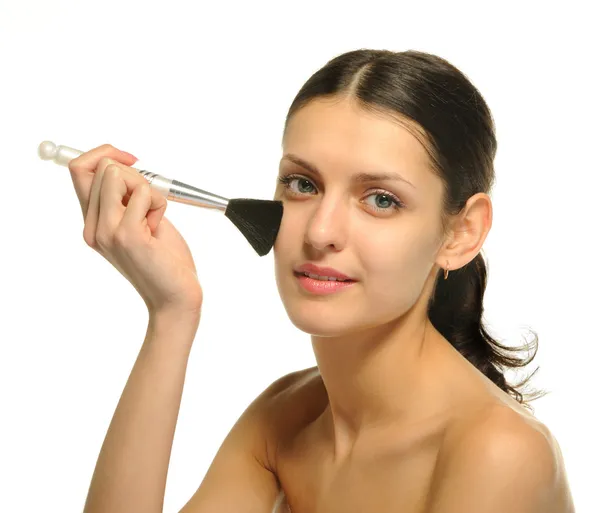 The pretty woman with a brush for a make — Stock Photo, Image