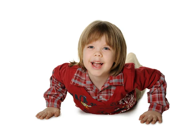 Il bambino si corica su un piano — Foto Stock