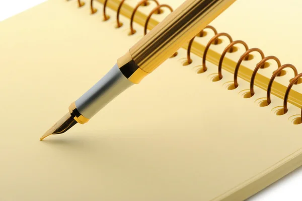 Fountain pen on a yellow notebook — Stock Photo, Image