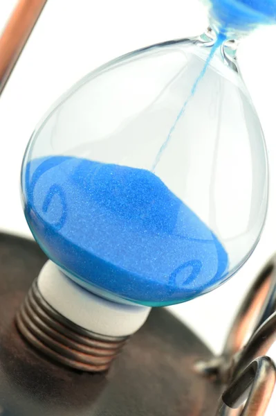 Песчаный стакан на долларах голубой тон — стоковое фото