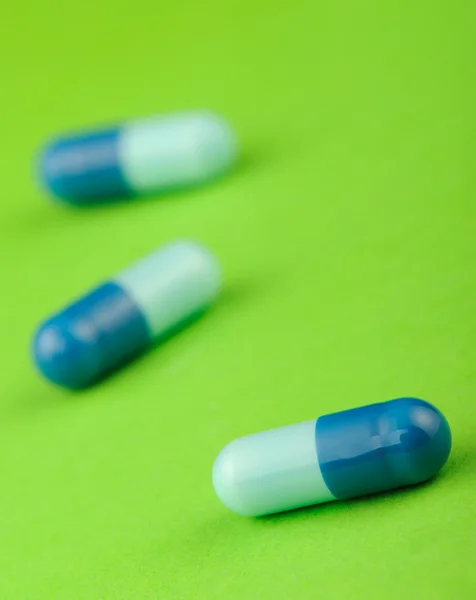 Set capsules on green background — Stock Photo, Image
