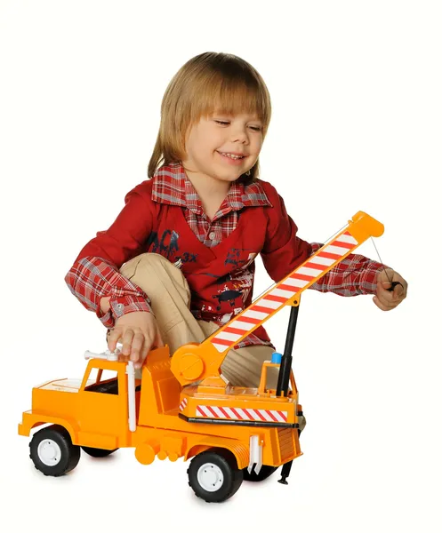 Boy with a toy - a truck crane — Stock Photo, Image