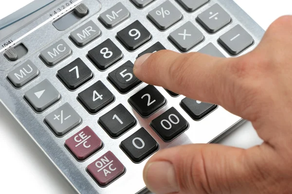 A calculadora e uma mão do homem — Fotografia de Stock