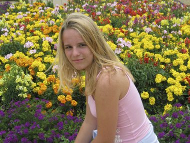 Young teenage girl between flowers clipart