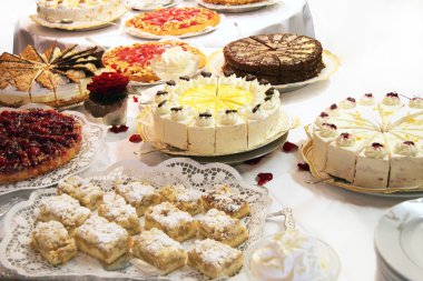 Cake buffet with various cakes clipart