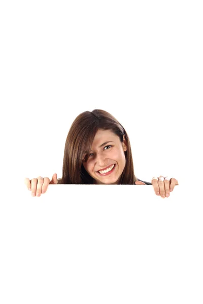 Woman looks out from behind an unmarked — Stock Photo, Image