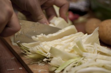 Woman cutting cabbage clipart