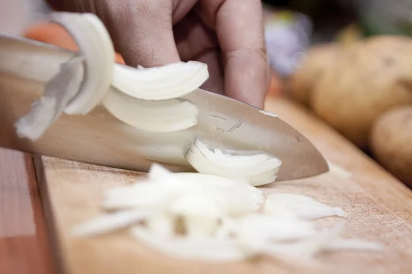 stock image Woman cutting onions