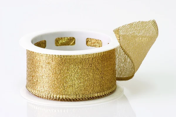 A spool of golden girft wrapping ribbon — Stock Photo, Image