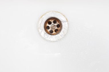 Water running down into rusty drain clipart