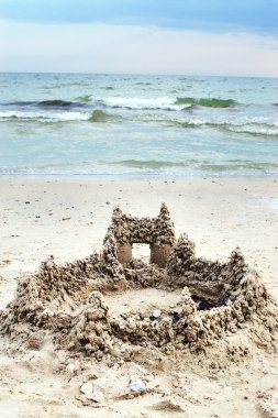 Castle from sand on sea beach clipart