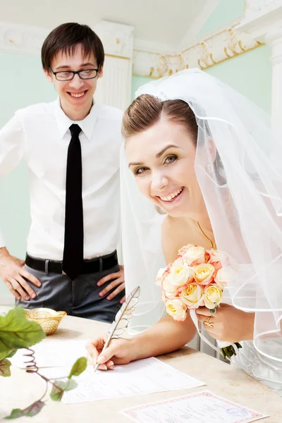 Bride signing a marriage certificate — Stock Photo, Image