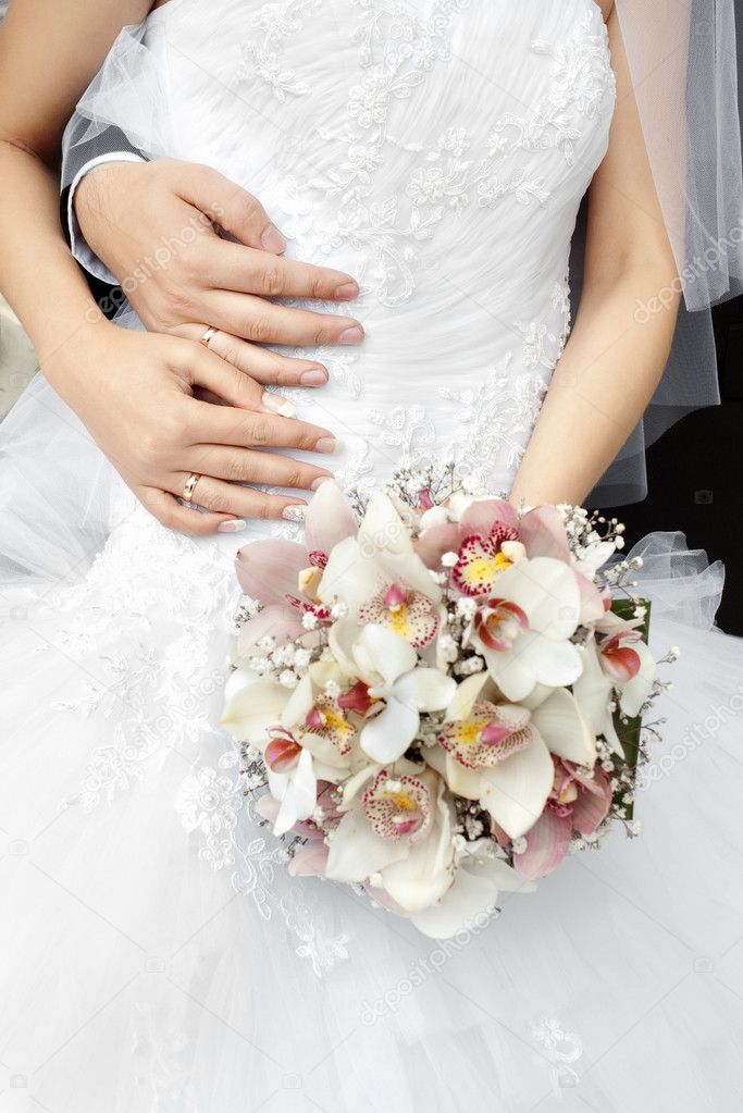 Part of bride with bouquet of flowers
