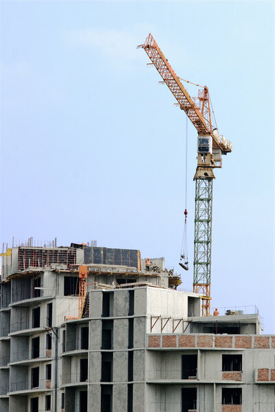 Construction site with crane against blue sky
