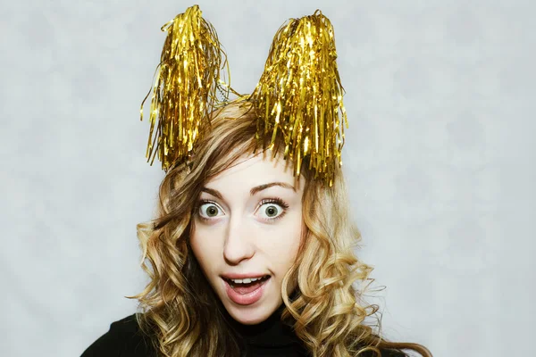 Girl with party golden tinsel horns — Stock Photo, Image