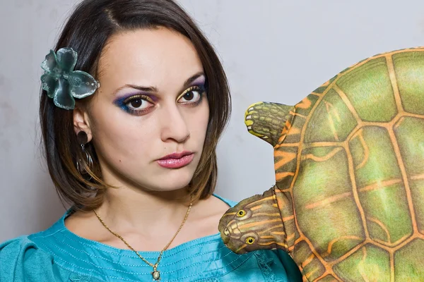 Pretty girl in blue with turtle toy — Stock Photo, Image