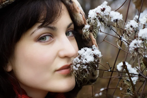 Kobieta pachnąca kwiat śniegu — Zdjęcie stockowe