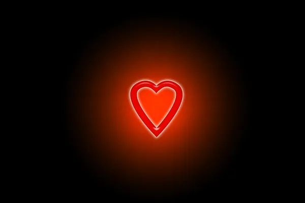 Corazón rojo brillando en la oscuridad en un círculo borroso — Foto de Stock