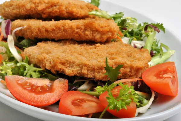 Breaded fish steak with organic herbs — Stock Photo, Image