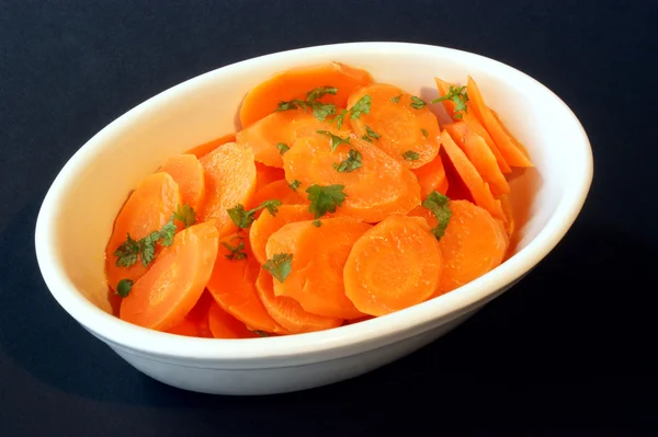 Braised organic carrot and a white bowl — Stock Photo, Image