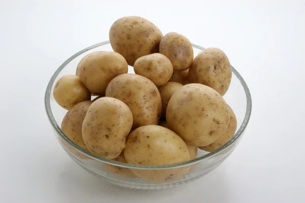 Some potatoes in a glass bowl — Stock Photo, Image