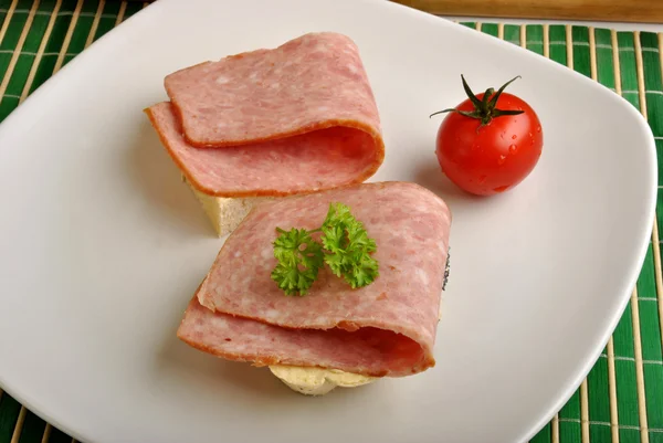 Half bread roll with ham — Stock Photo, Image