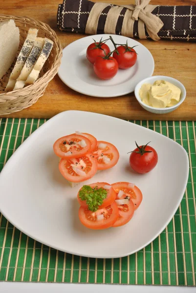 Half bread roll with tomato slices — Stock Photo, Image