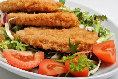 Breaded fish steak with organic herbs clipart