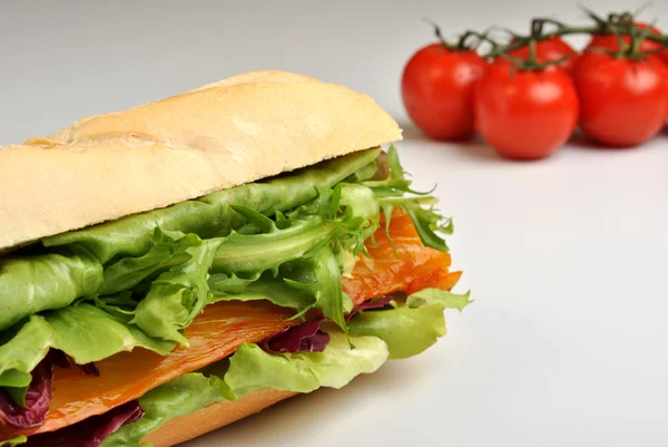 Bread roll with organic smoked salmon — Stock Photo, Image