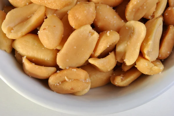 Roasted salted peanuts in a white bowl — Stock Photo, Image