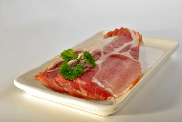 Smoked bacon on a plate — Stock Photo, Image