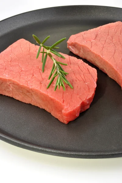 Raw organic steak with rosemary — Stock Photo, Image