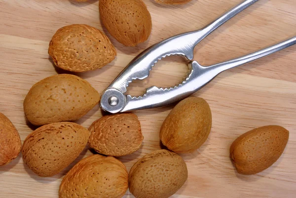Healthy almonds and a nutcracker — Stock Photo, Image