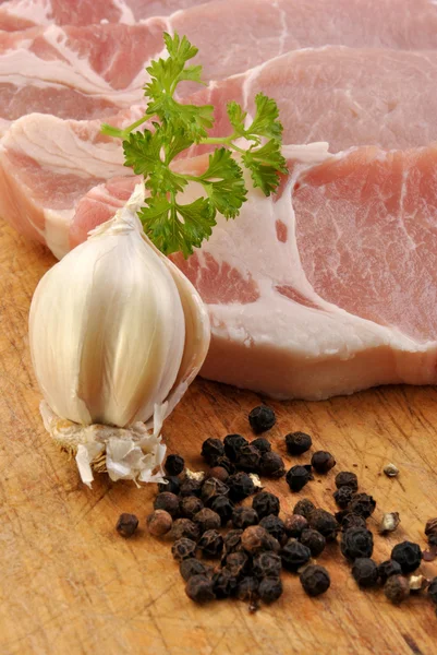 Some raw organic pork chop and parsley — Stok fotoğraf