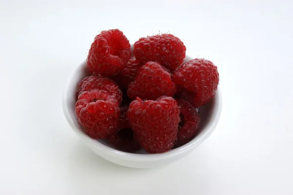 Raspberries in a white bowl — Stock Photo, Image