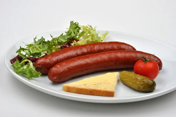 Smoked sausage and gherkin — Stock Photo, Image