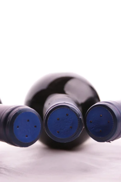Redwinebottle with a blue cap — Stock Photo, Image