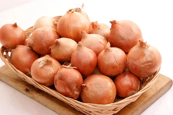 Onions in hand made basket — Stock Photo, Image