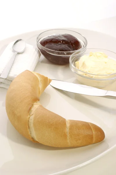 Croissant auf einem Teller zum Frühstück — Stockfoto